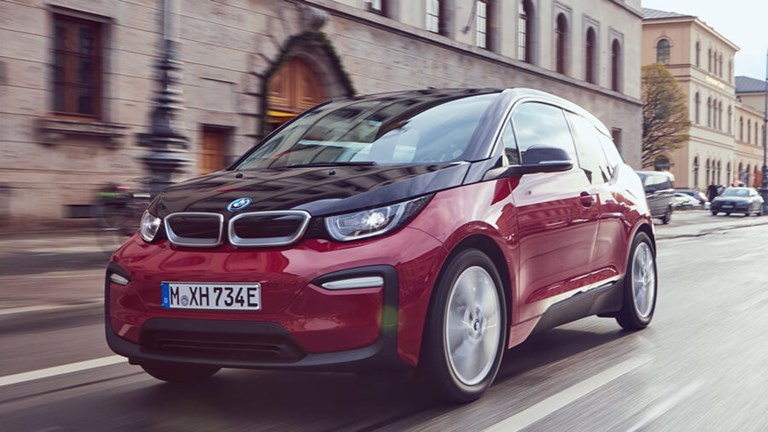 Hybrid, eco-friendly BMW rental car being driven in the city.